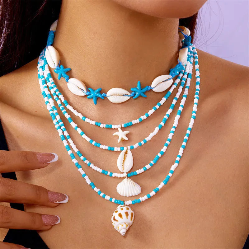Five multi-layer women's necklaces with starfish shell conch bead designs in blue and mixed colours