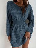 Blue women's knit dress with loose round neck, fitted waist, and hand-crocheted flower decoration