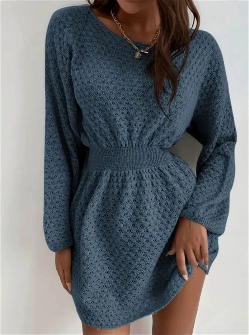 Blue women's knit dress with loose round neck, fitted waist, and hand-crocheted flower decoration