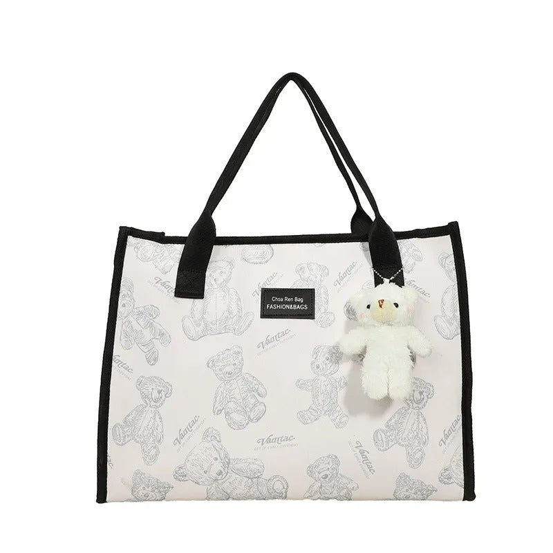 Women's black canvas tote bag with rhombus pattern and shoulder strap