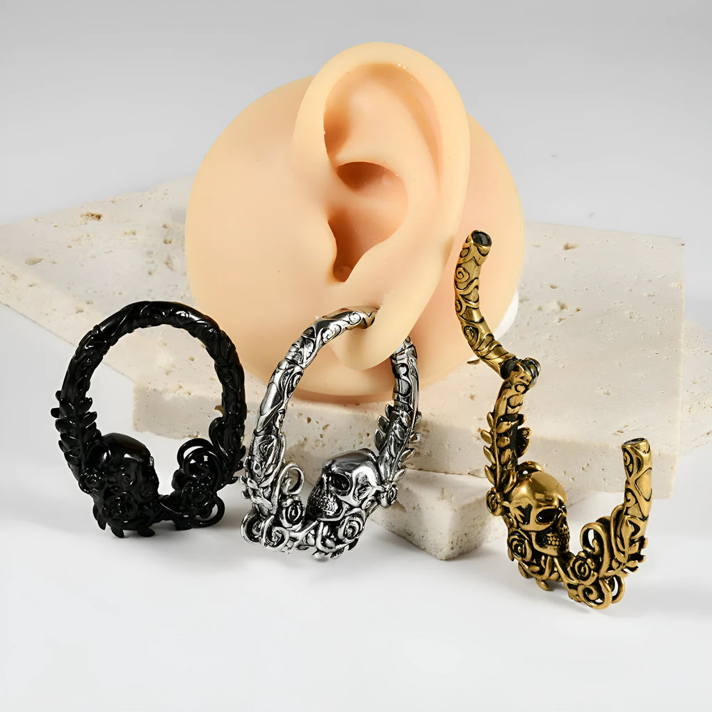 A pair of stainless steel fashion earrings featuring a shaped totem pattern in an electroplated finish.