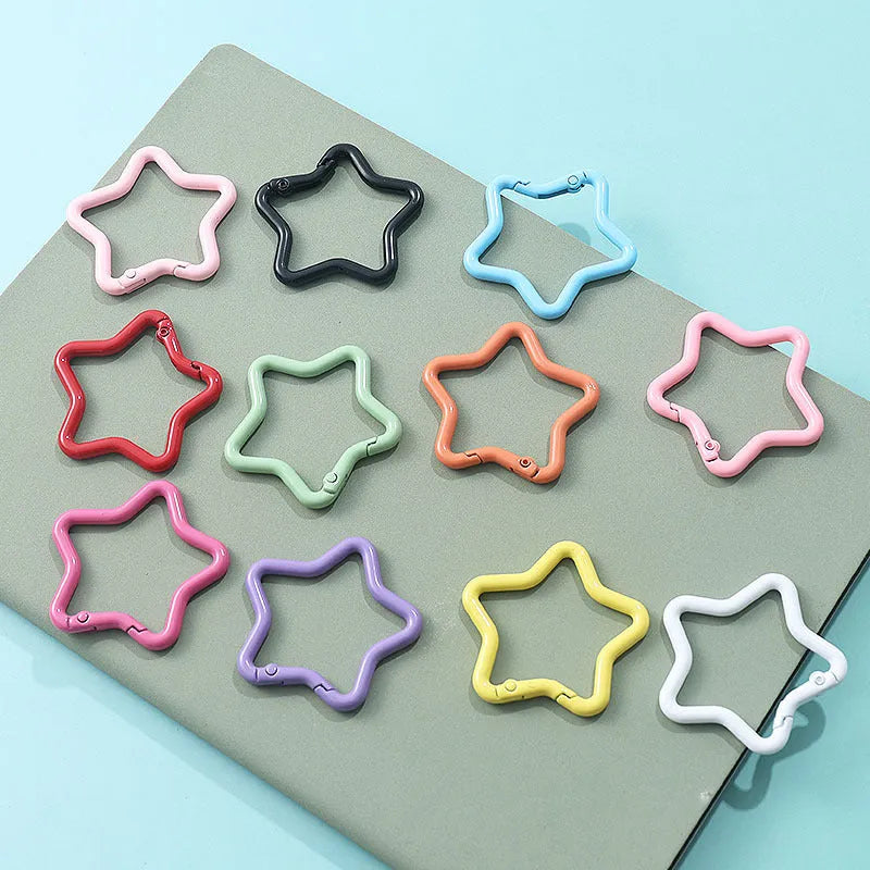 Zinc alloy five-pointed star keychain in multiple macaron colours including pink, blue, and purple