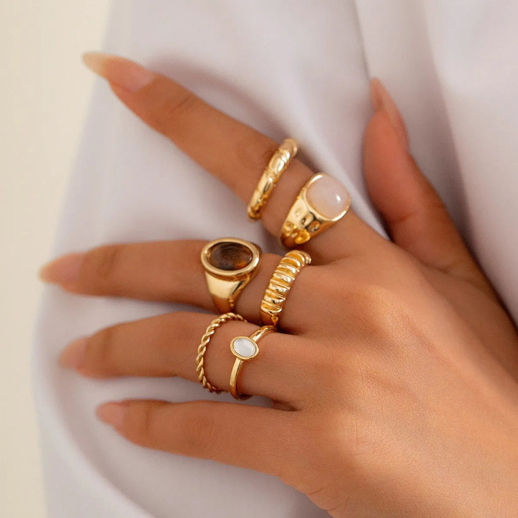 Six light gold geometric and round alloy rings for women displayed together