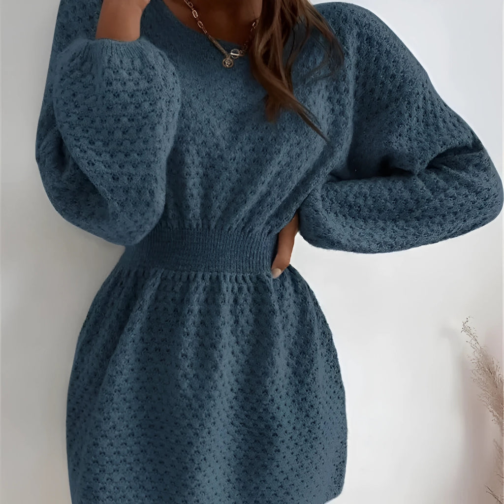 Blue women's knit dress with loose round neck, fitted waist, and hand-crocheted flower decoration
