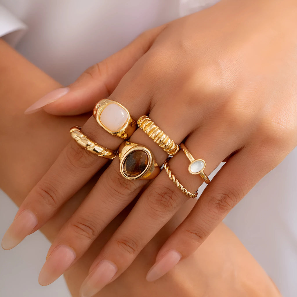 Six light gold geometric and round alloy rings for women displayed together