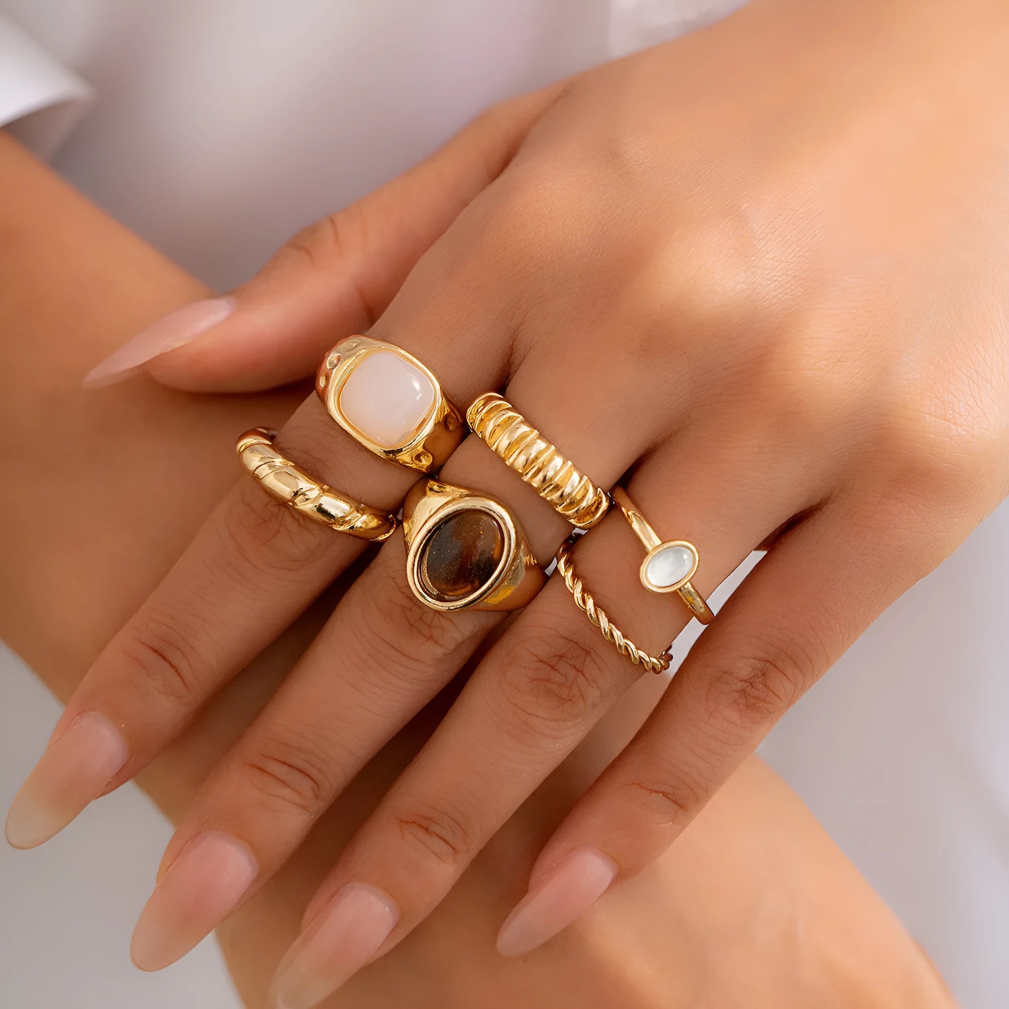 Six light gold geometric and round alloy rings for women displayed together