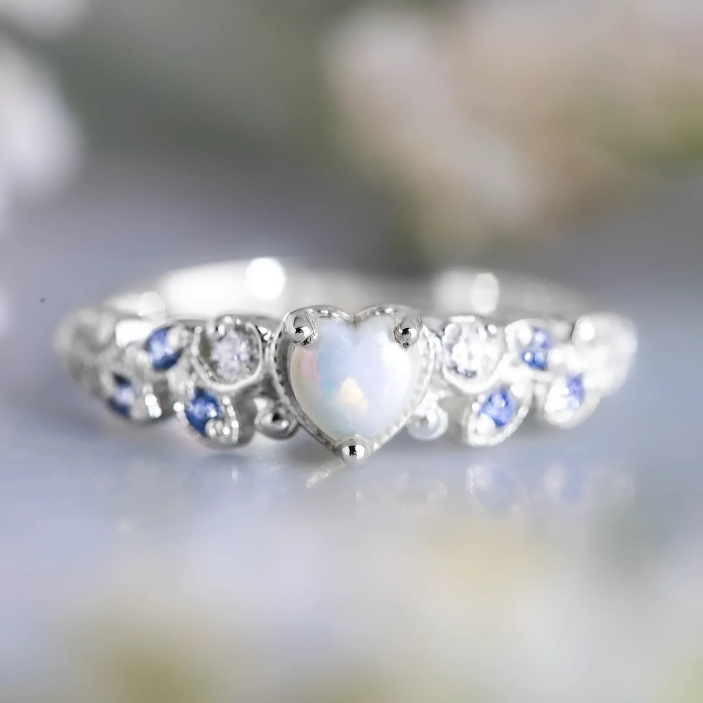 White alloy heart-shaped ring with floral opal ocean design shown in size 10.