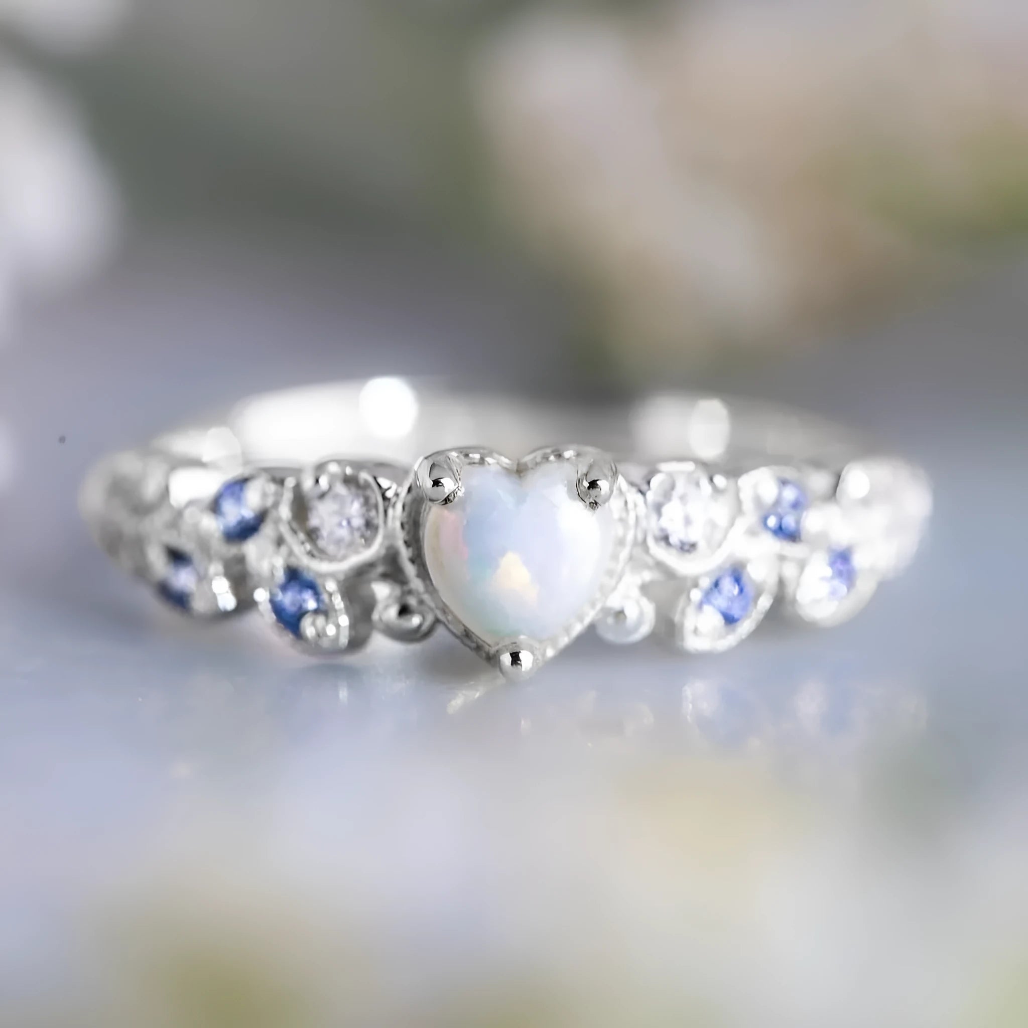 White alloy heart-shaped ring with floral opal ocean design shown in size 10.