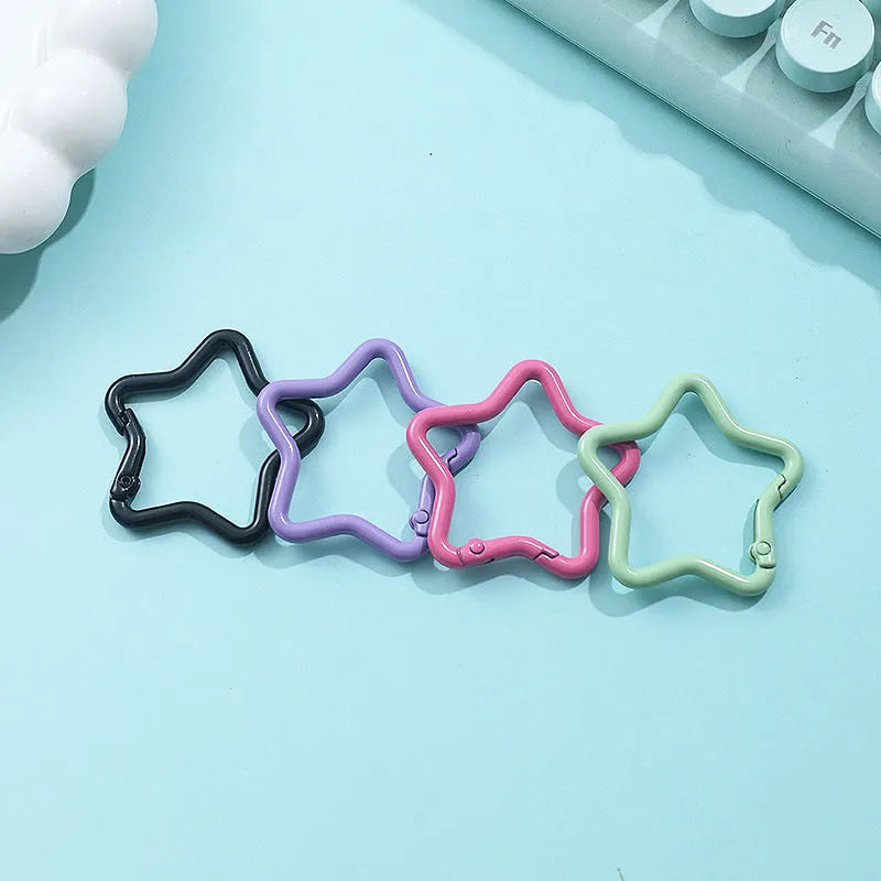 Zinc alloy five-pointed star keychain in multiple macaron colours including pink, blue, and purple