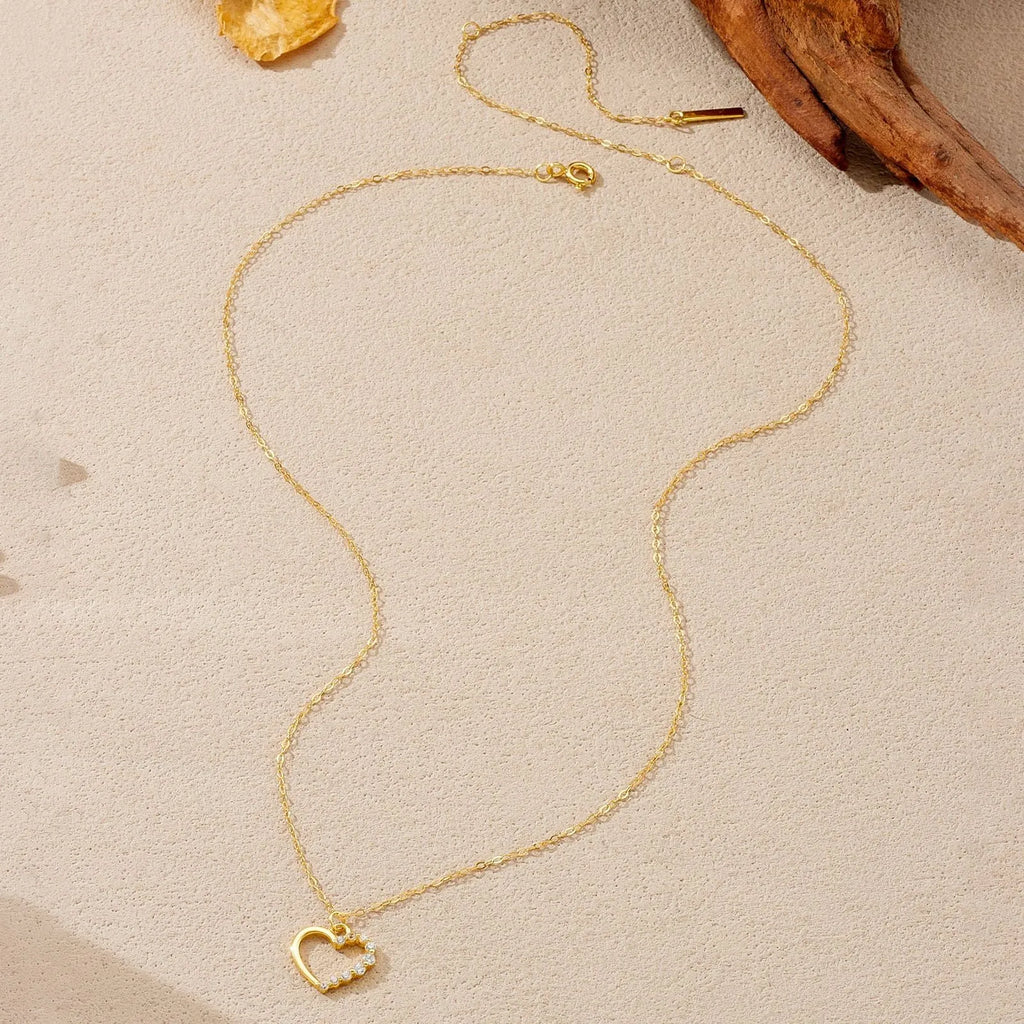 Sterling silver hollow heart pendant necklace on a regular chain, available in white gold or platinum plating.