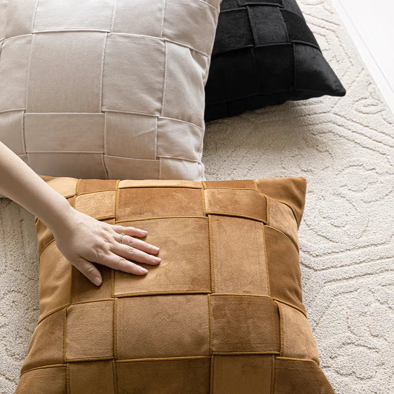 Square chenille woven sofa cushion in taupe colour on a grey sofa, showing textured fabric detail