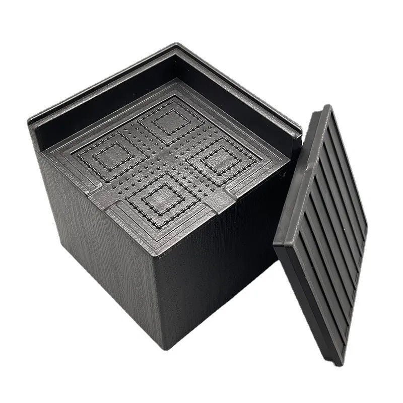 Four black plastic bed foot mats for furniture height adjustment and leg stabilisation
