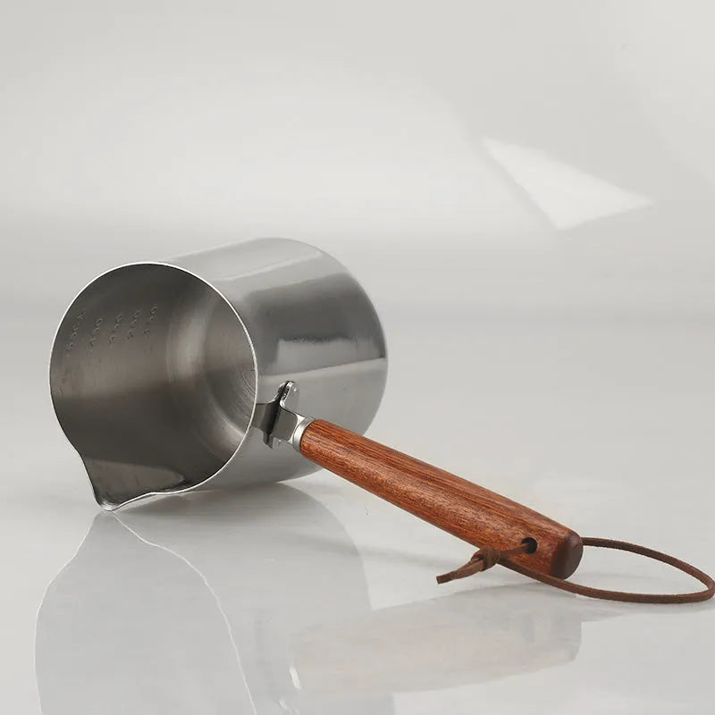 Stainless steel garland coffee cup with a scaled wooden handle shown in a simple solid colour.