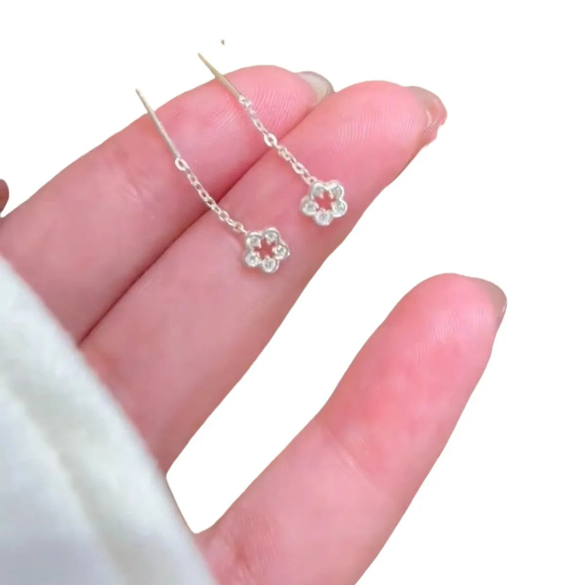 Silver hollow flower drop earrings with natural petal design and butterfly closure