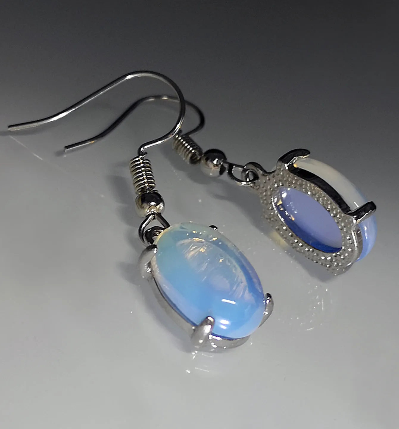 Moonlight white opal drop earrings with cross-shaped retro design and electroplated alloy finish