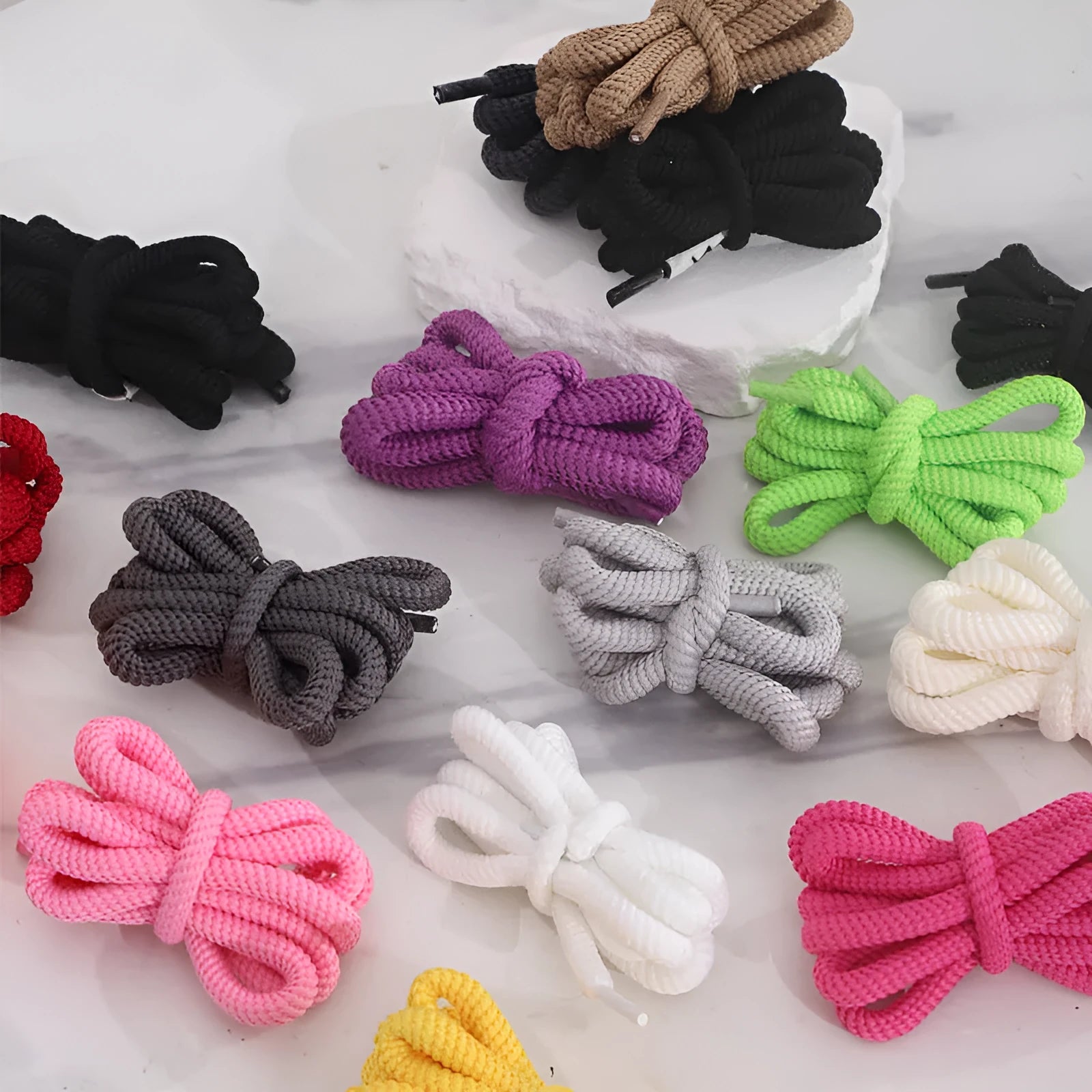 Set of oval 1.0mm wide replacement shoelaces in multiple colours including black, pink, red, and blue, shown in various lengths.