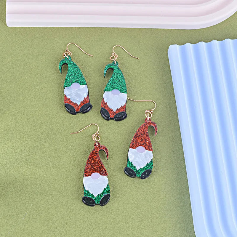 A pair of acrylic earrings shaped like cartoon Santa Claus figures with coloured hats.