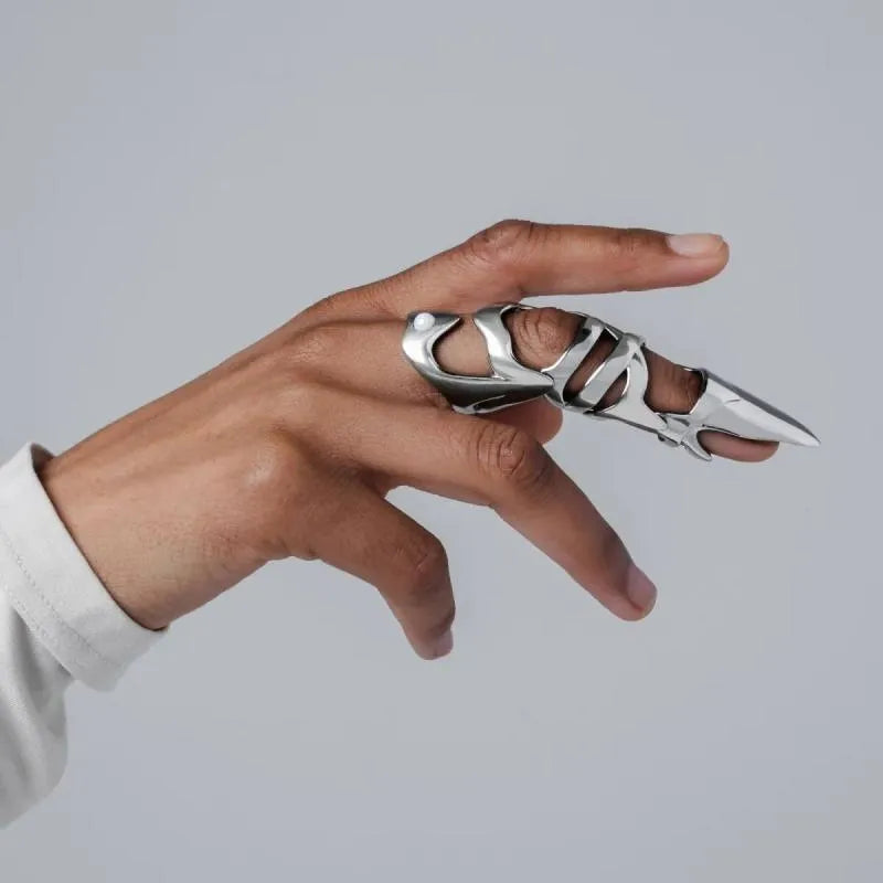 Silver alloy punk armour finger stall covering a knuckle.