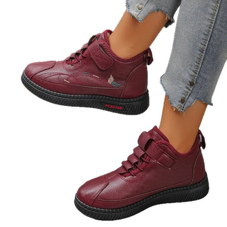 Women's black velvet cotton shoes with hollow-out design and textured rubber sole.