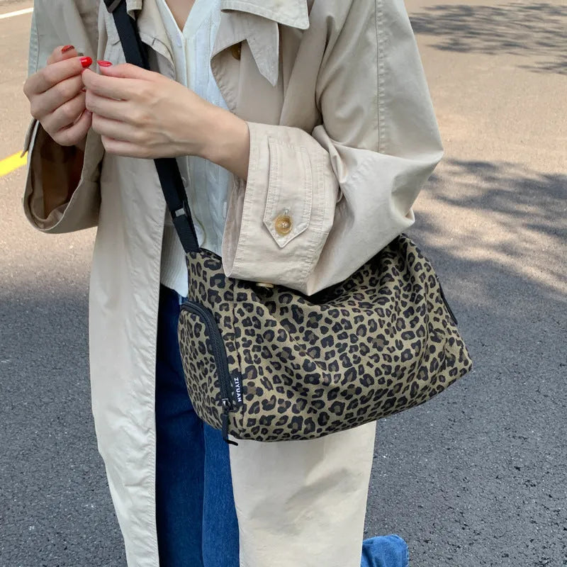 Leopard print crossbody messenger bag with stitching details and shoulder strap