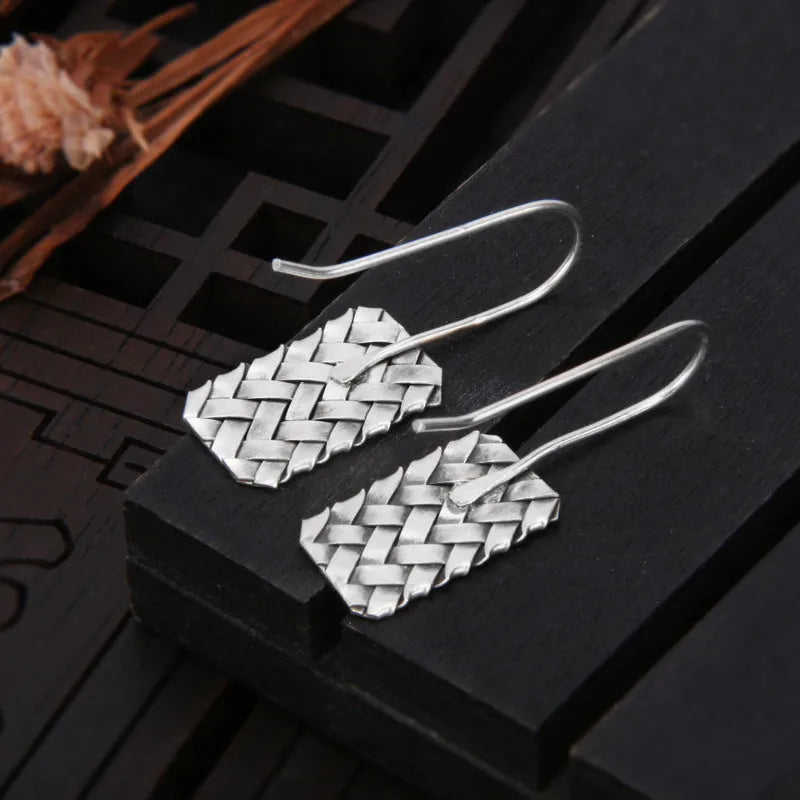 Sterling silver rectangular drop earrings with a woven diamond plaid geometric pattern.