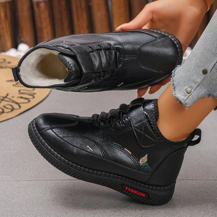 Women's black velvet cotton shoes with hollow-out design and textured rubber sole.
