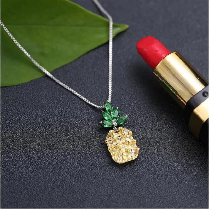 Silver pineapple charm necklace with geometric diamond pattern on adjustable chain