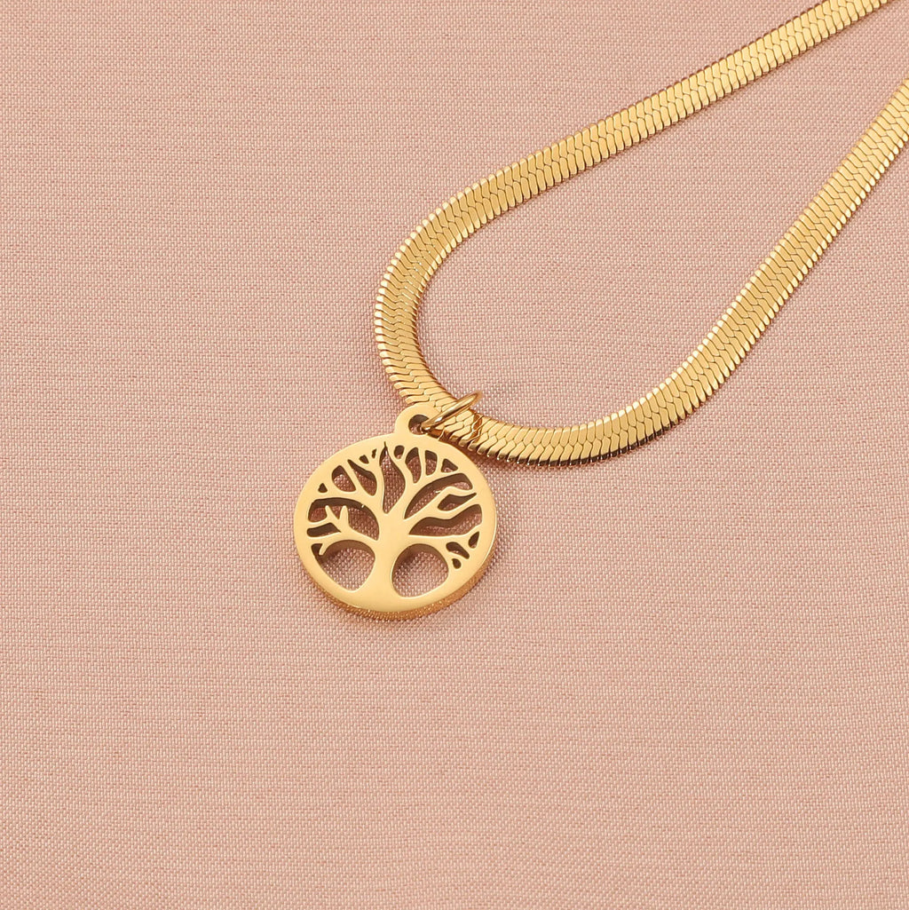 Steel colour tree pendant necklace with a textured snake bones chain on a neutral background.