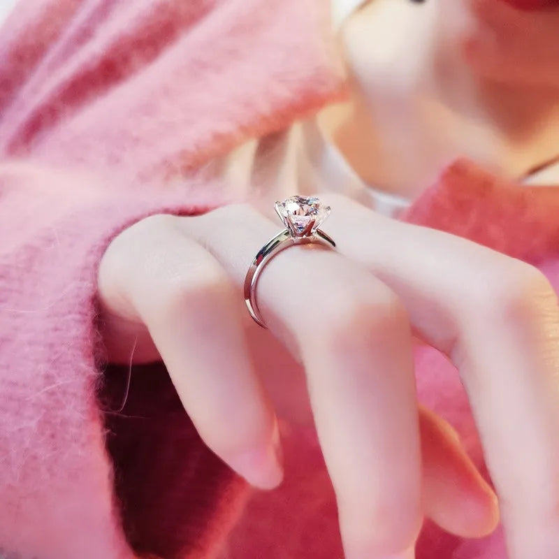 White gold plated geometric ring with six-claw setting holding a zircon stone.