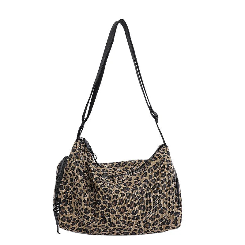 Leopard print crossbody messenger bag with stitching details and shoulder strap