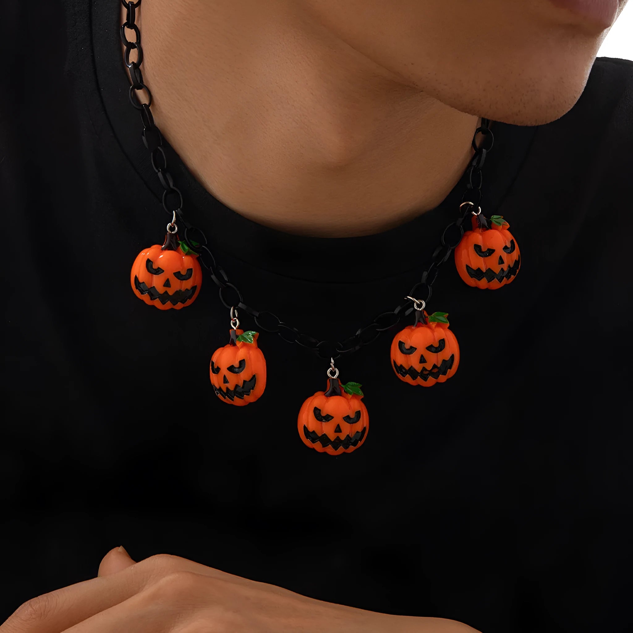 Colourful Halloween necklace showing a cartoon ghost pumpkin pendant on a chain.