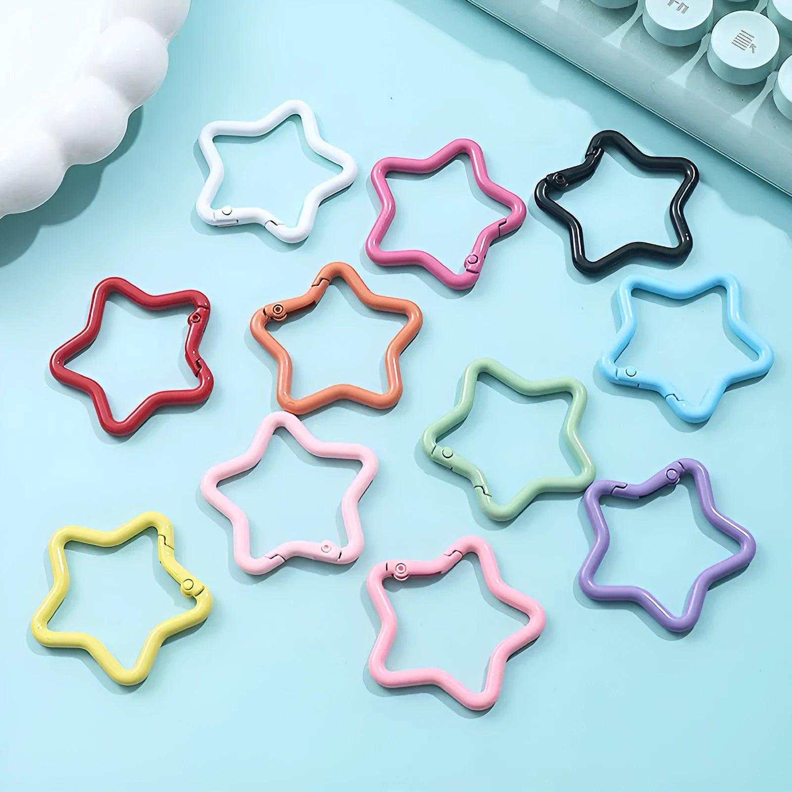 Zinc alloy five-pointed star keychain in multiple macaron colours including pink, blue, and purple