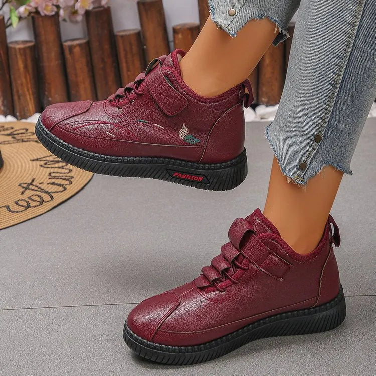 Women's black velvet cotton shoes with hollow-out design and textured rubber sole.