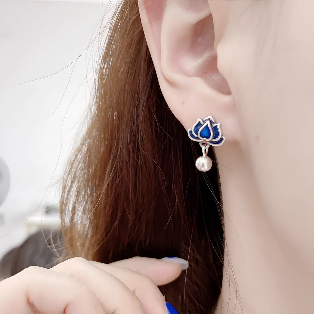 A pair of alloy lotus ear studs with retro seedpod tassel design, shown in lotus colour.