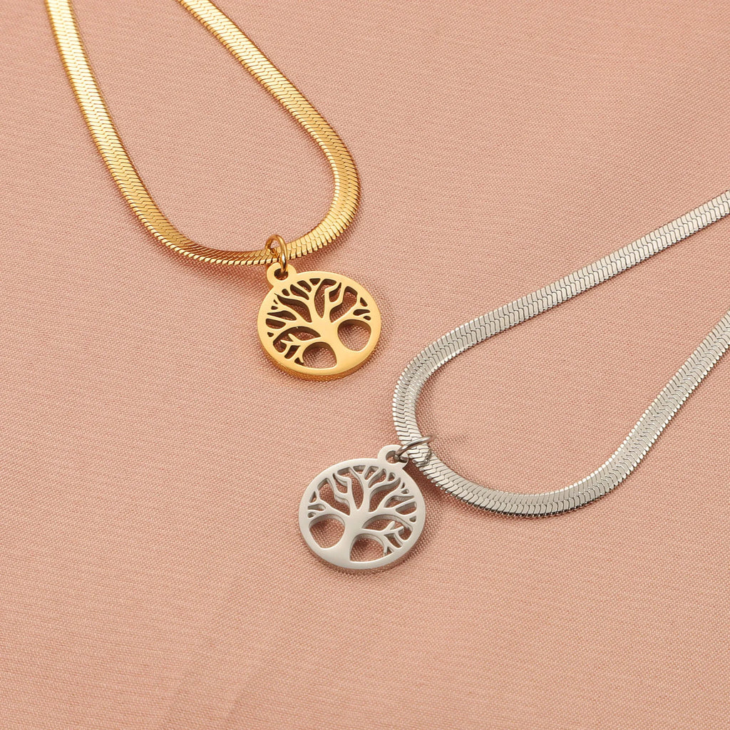 Steel colour tree pendant necklace with a textured snake bones chain on a neutral background.