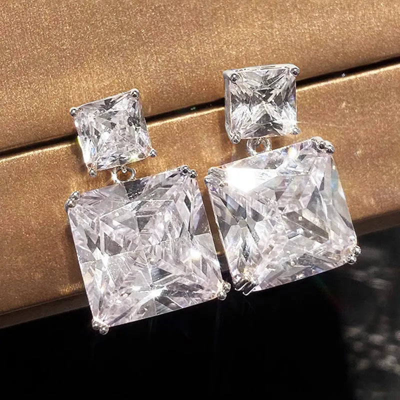 A pair of geometric square design copper earrings in a choice of white gold or gold colour.
