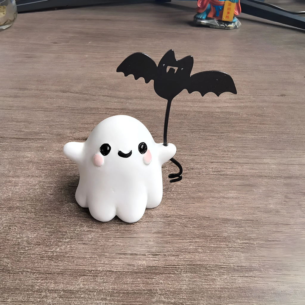 Mini resin statue of a ghost walking a dog and holding a bat, a Halloween ornament.
