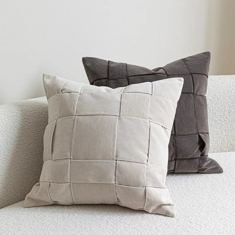 Square chenille woven sofa cushion in taupe colour on a grey sofa, showing textured fabric detail