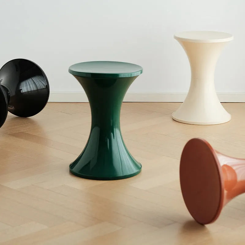 Plastic hourglass shoe changing stool in green colour showing contoured seating design