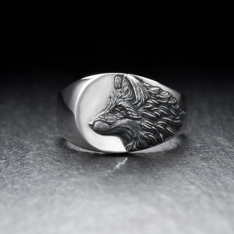Silver geometric wolf-shaped alloy ring for men on a plain background.