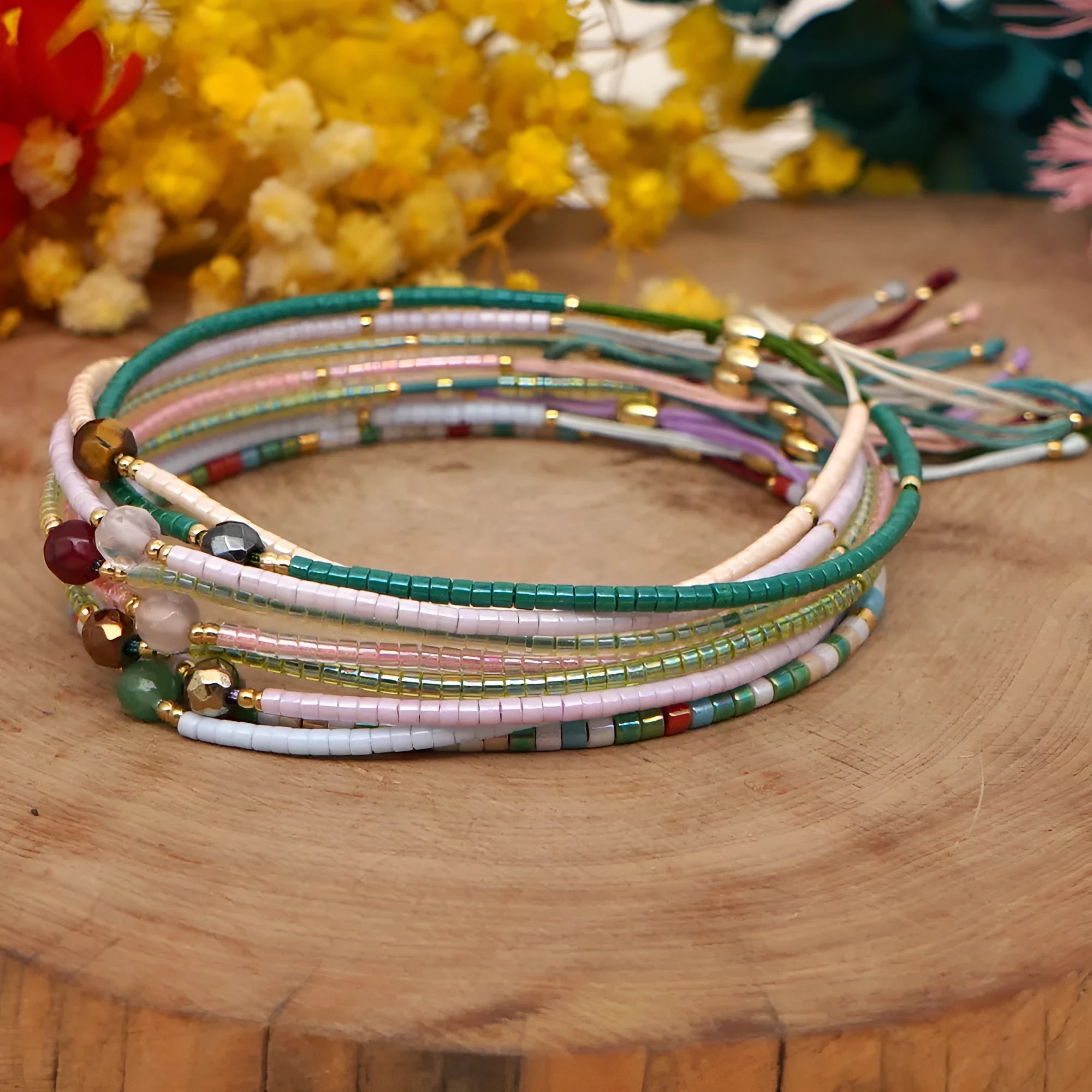 Handmade bohemian bracelet with semi-precious stone and colourful glass beads on a wrist.