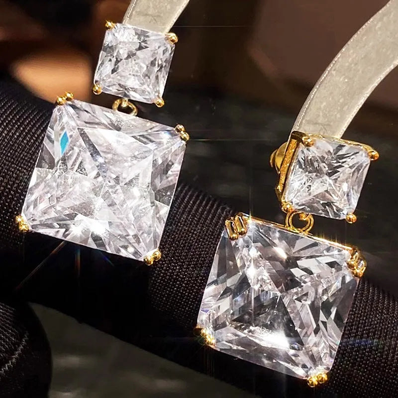 A pair of geometric square design copper earrings in a choice of white gold or gold colour.