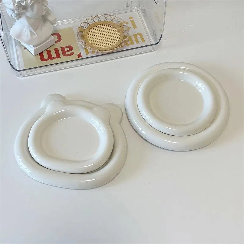 White porcelain plate with cute bear doodle design, 20cm size, on a table.