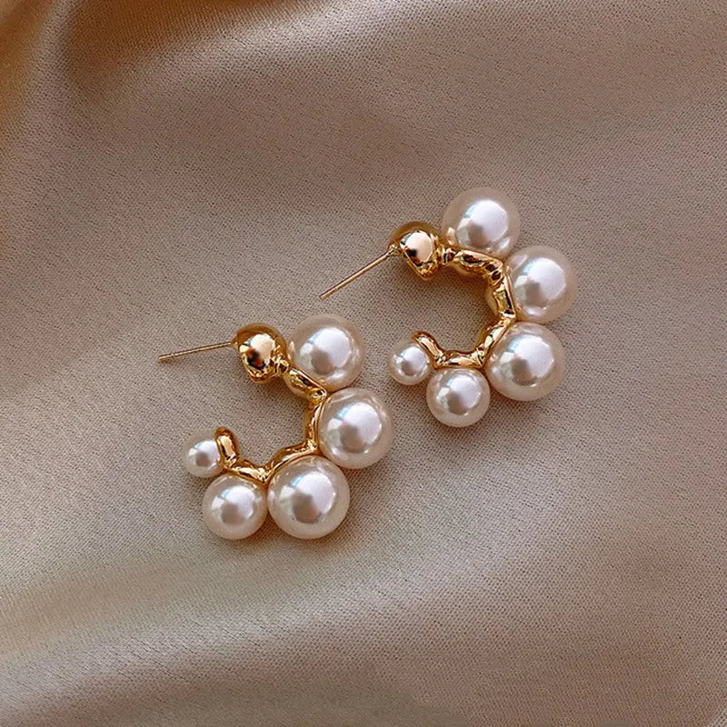 A pair of women's bell-shaped drop earrings in alloy, shown in red and white colour options.