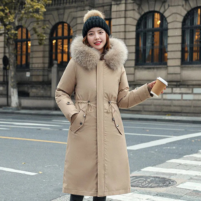 Women's long beige trench coat with fleece lining and button front.