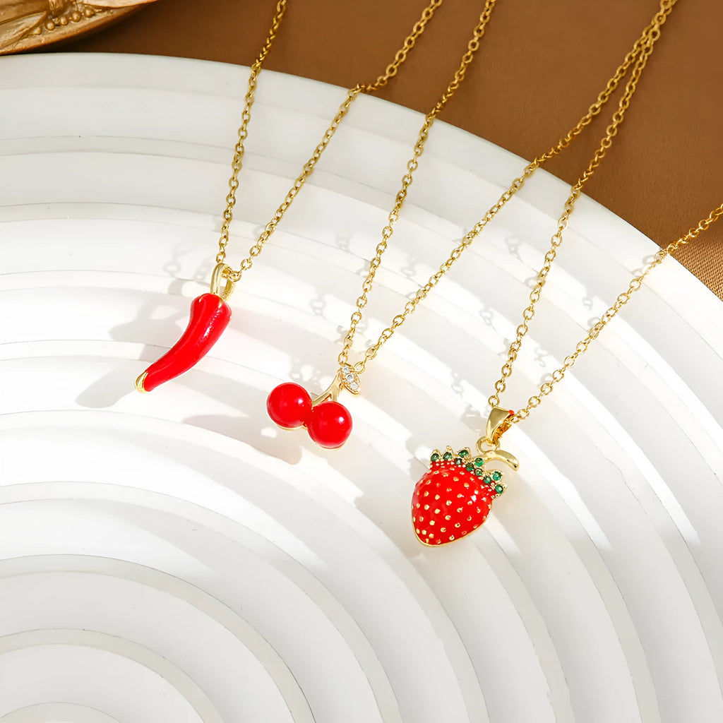 Indie fashion necklace with delicate cherry, strawberry and pepper pendant on a titanium steel O-ring chain.