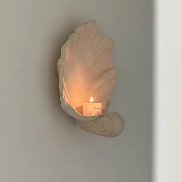 White resin shell-shaped fruit plate ornament with light luxury styling on a table.