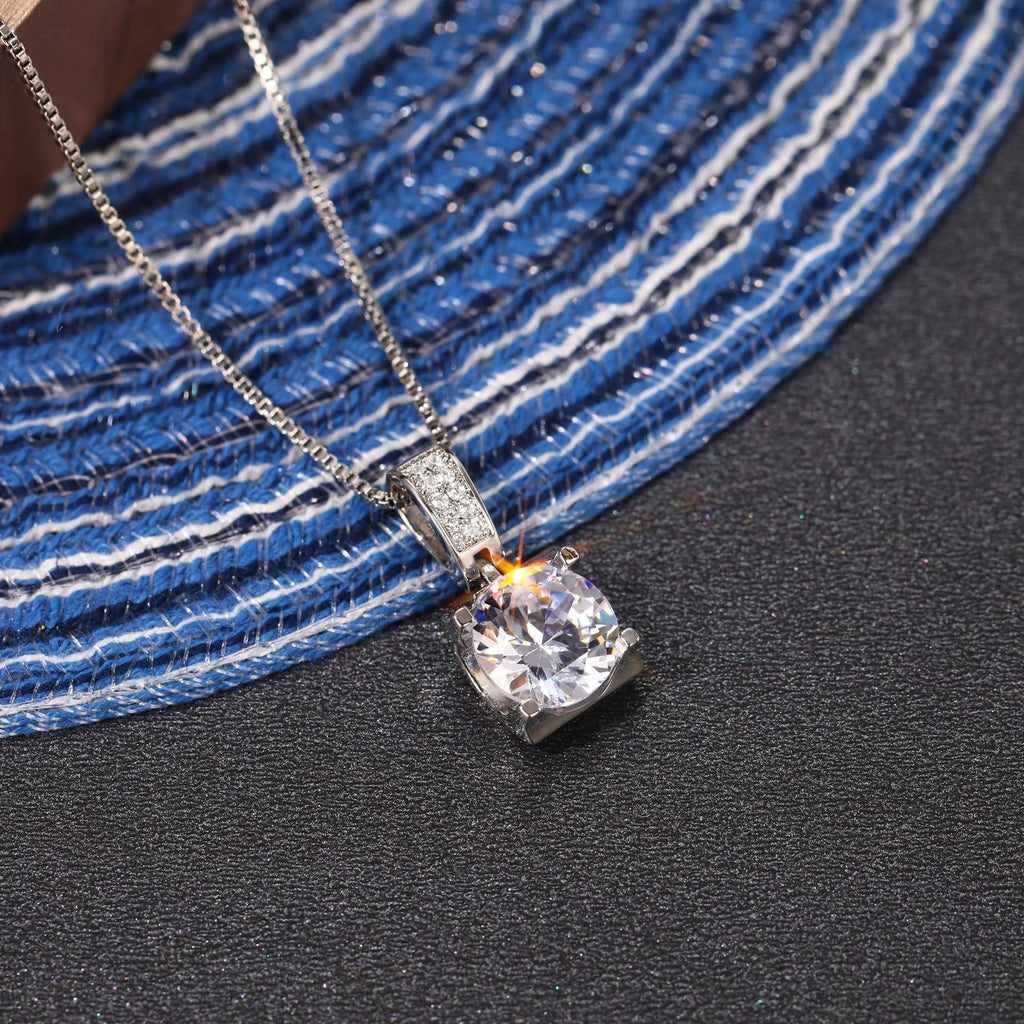 Copper clavicle chain with artificial diamond round pendant in XL484 white gold finish on female model