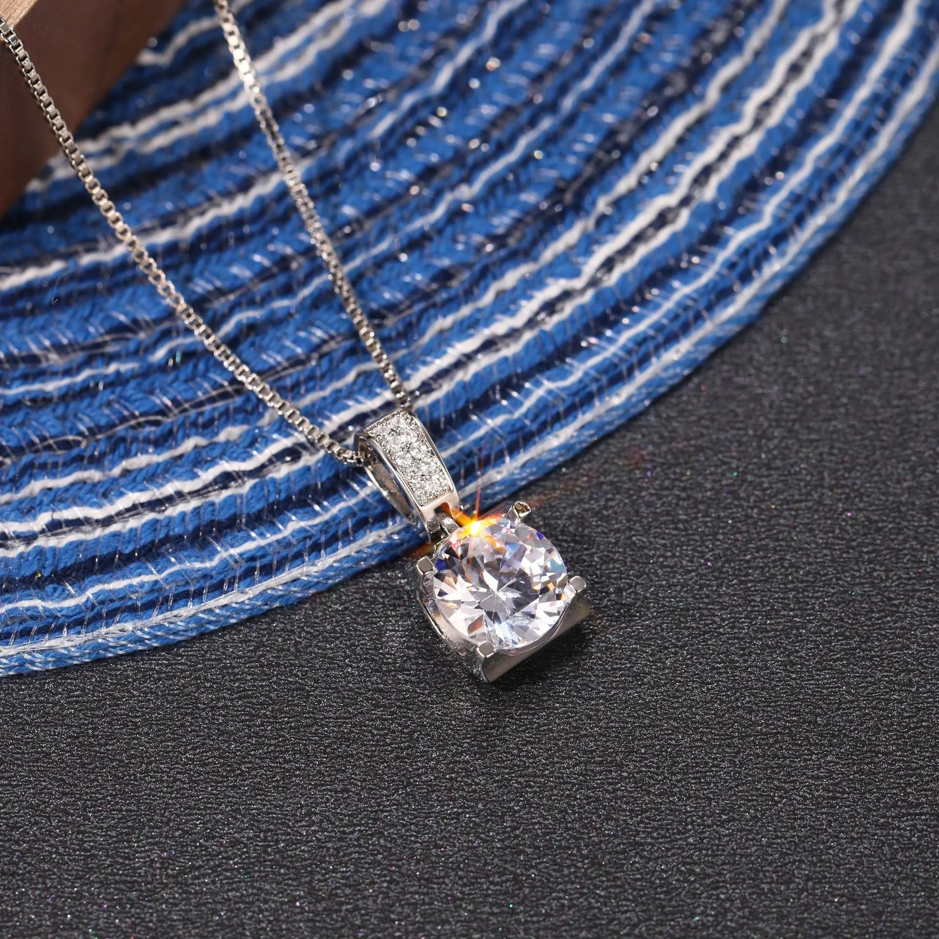 Copper clavicle chain with artificial diamond round pendant in XL484 white gold finish on female model