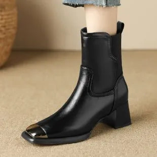 Brown leather women's Martin boots with a high heel and side zipper on a white background.